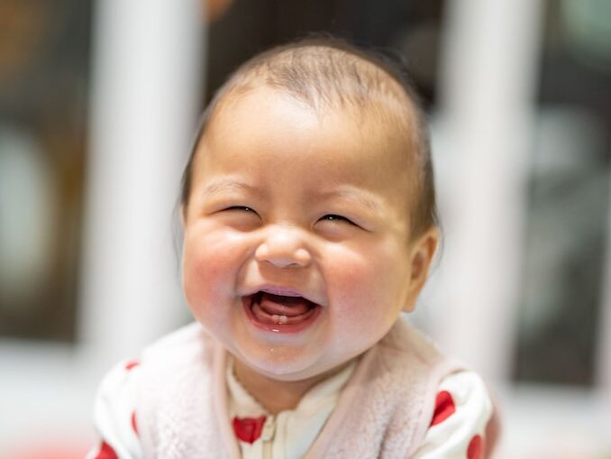 baby in white and red heart print onesie