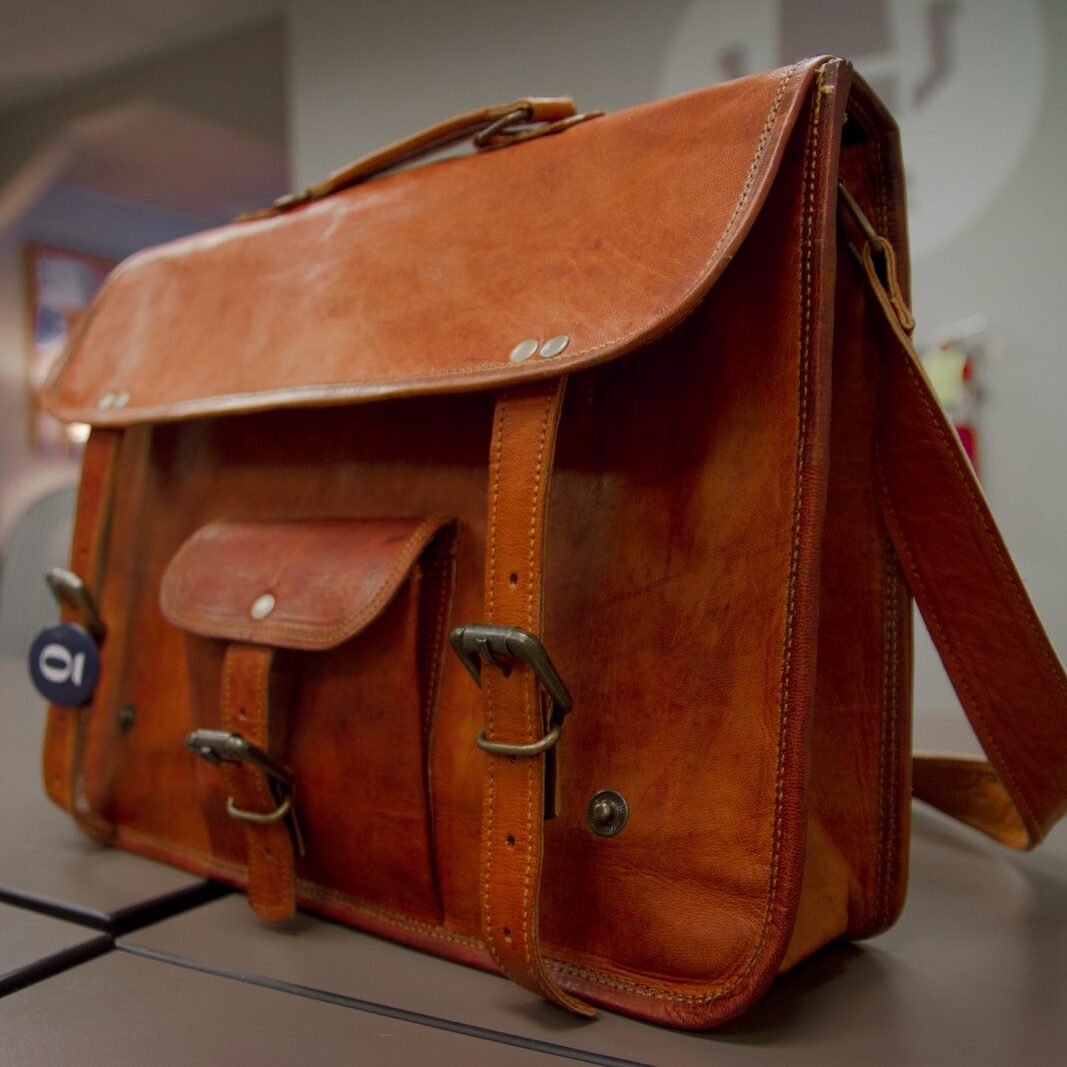 closeup photo of brown leather crossbody bag